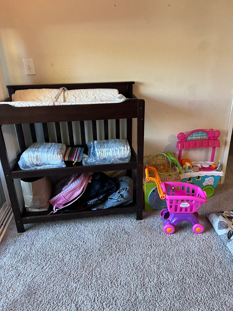 Baby changing station stocked with diapers and supplies